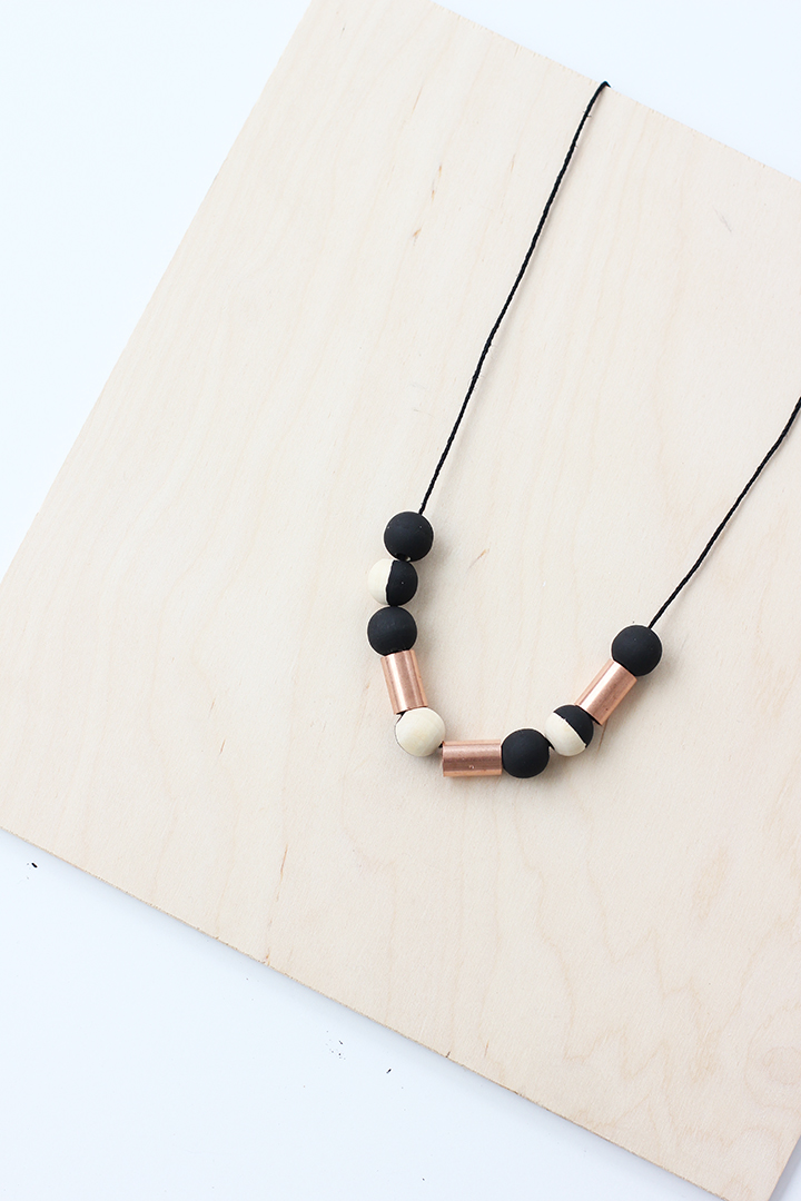 Make this handmade wood bead necklace with copper beads from the hardware store. Perfect for your Fall outfits. 