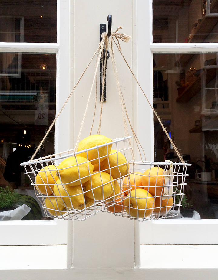 Lemons hanging in a basket on Amsterdam storefront