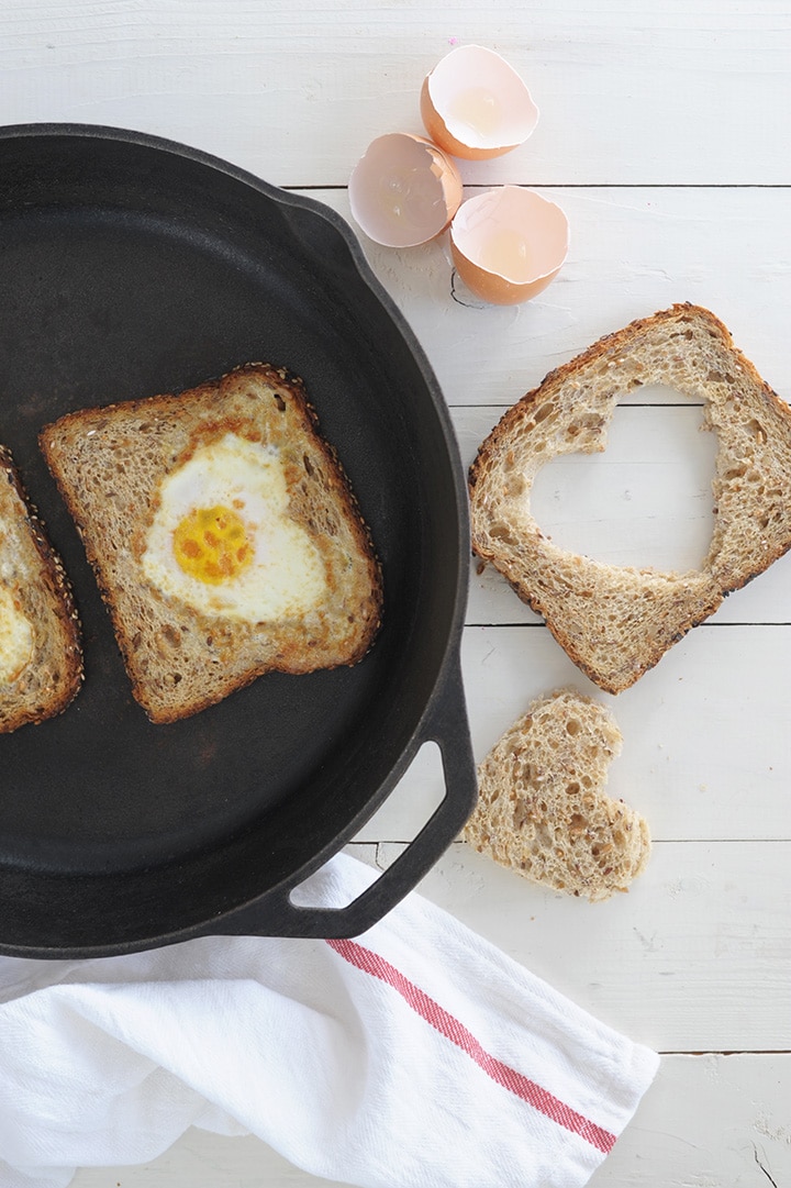 Such a simple, healthy breakfast to celebrate Valentine's Day. Heart-shaped eggs and toast along with watermelon pops!