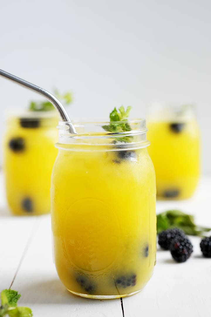 Love making these Mango Blackberry Vodka Cocktails in mason jars for a summer party!