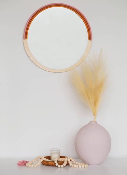 circle mirror with yarn wrapped rope displayed pampas grass